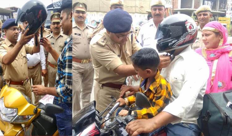 एसपी अजय कुमार ने वाहन चालको को खुद पहनाए हैलमेट